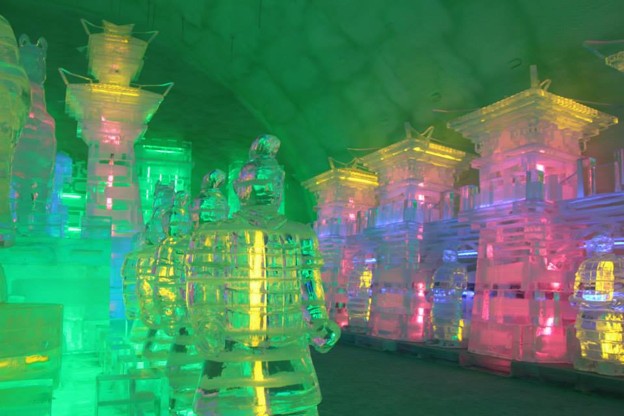 Picture26 - The Canada Times Ice carving exhibit with colorful illuminated sculptures and pagoda-style structures glowing in green, blue, and pink.