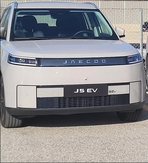 12 - The Canada Times Front view of a white JAECO JS EV BEV electric vehicle, showing the grille, headlights, and front bumper with 'JS EV' on the plate area.