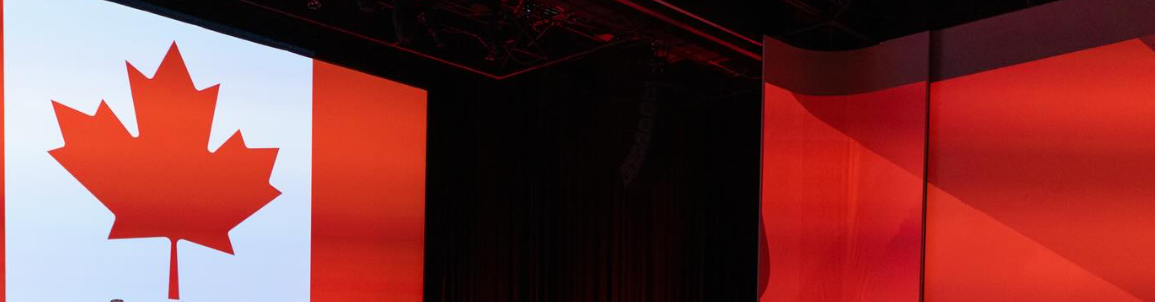 8 - The Canada Times Canadian flag on a white panel projected on a stage left with red scenery to the right