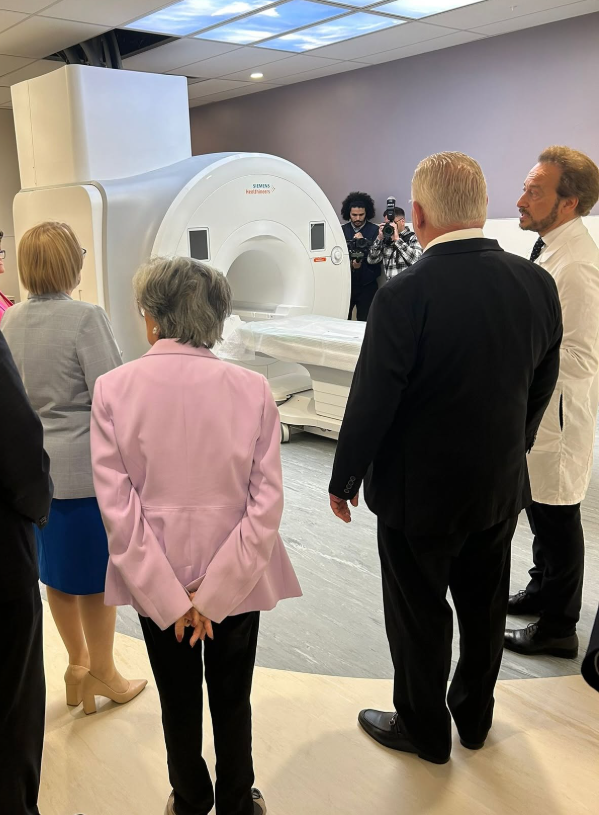 5 - The Canada Times Group of professionals standing around a large Siemens MRI scanner during a demonstration in a medical facility.