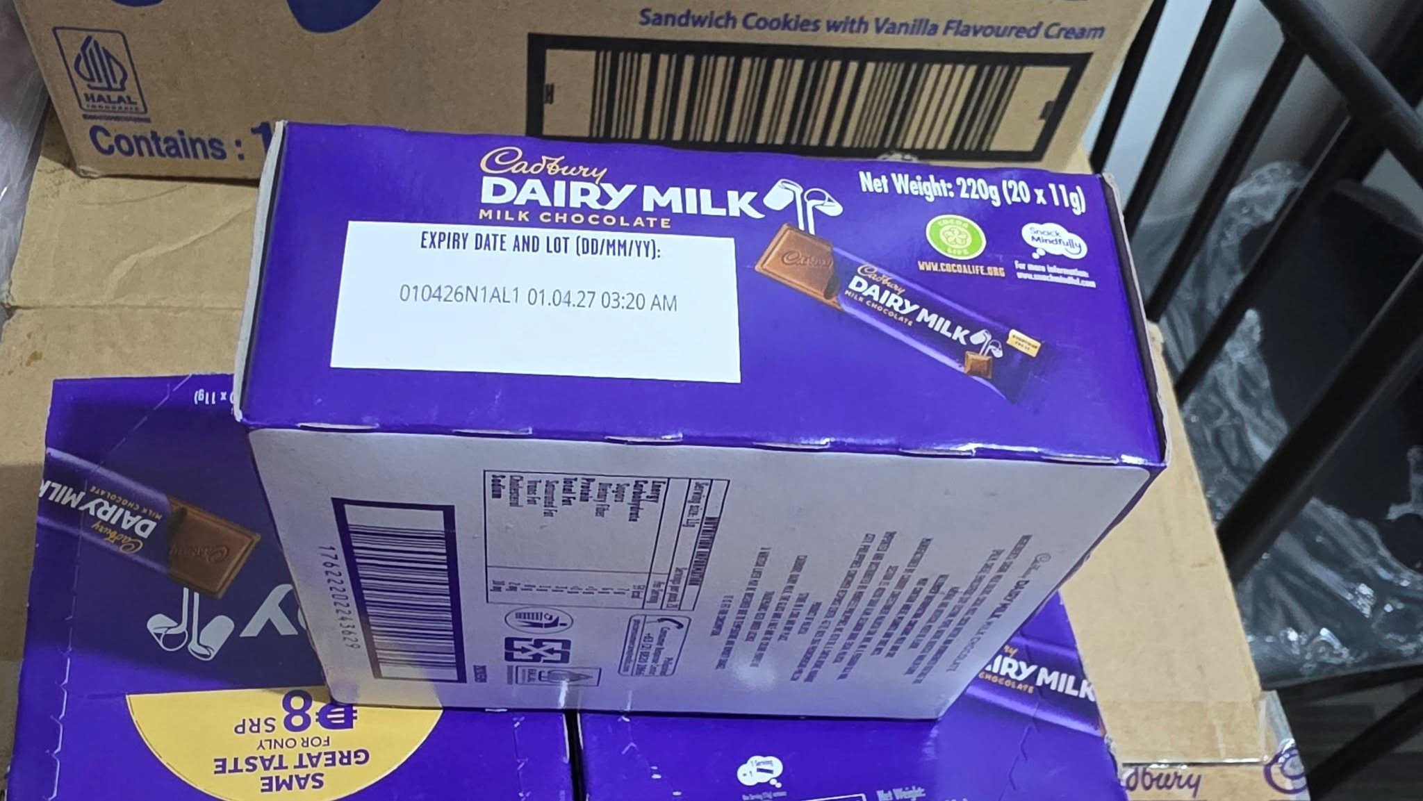 4 - The Canada Times Stack of Cadbury Dairy Milk chocolate boxes in a cardboard carton storage box.