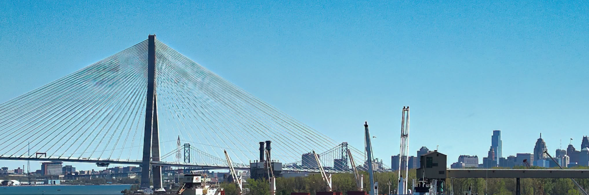 7 - The Canada Times Cable-stayed bridge with a tall central pylon and many cables over a river, city skyline in the background.